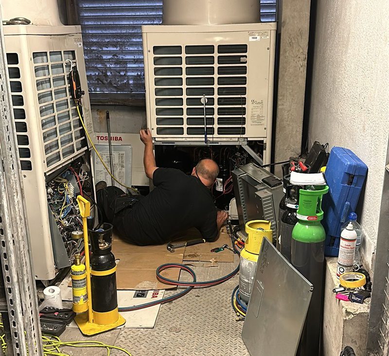 Air conditioning unit being fitted in office